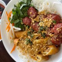 55. Grilled Pork Sausage and Spring roll Vermicelli · Bun Nem Nuong and Cha gio served over bed of vermicelli noodles, lettuce, cucumber, basil, m...