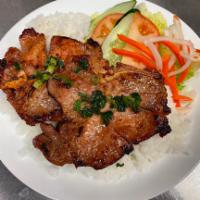 61. BBQ Pork Chops Rice Plate · Com Suon. Traditional vietnamese pork chop rice plate served with small salad, cucumber, tom...