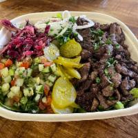 Steak Shawarma Salad · A bed of romaine lettuce with meat, toppings and sauce. Served with pita (or tell us to skip...