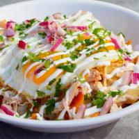 Chilaquiles Bowl · Corn tortilla chips sauteed with red or green sauce. Topped with Jack cheese, 2 eggs, red on...