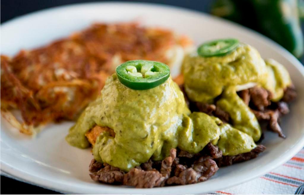 Border Benedict · Poached eggs, seasoned carne asada and sweet corn cakes topped with our homemade poblano sauce and fresh sliced jalapeno.
