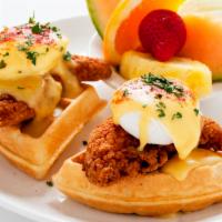 Chicken & Waffle Benedict · Two Belgian waffle quarters topped with crispy chicken tenders, poached eggs and holandaise ...