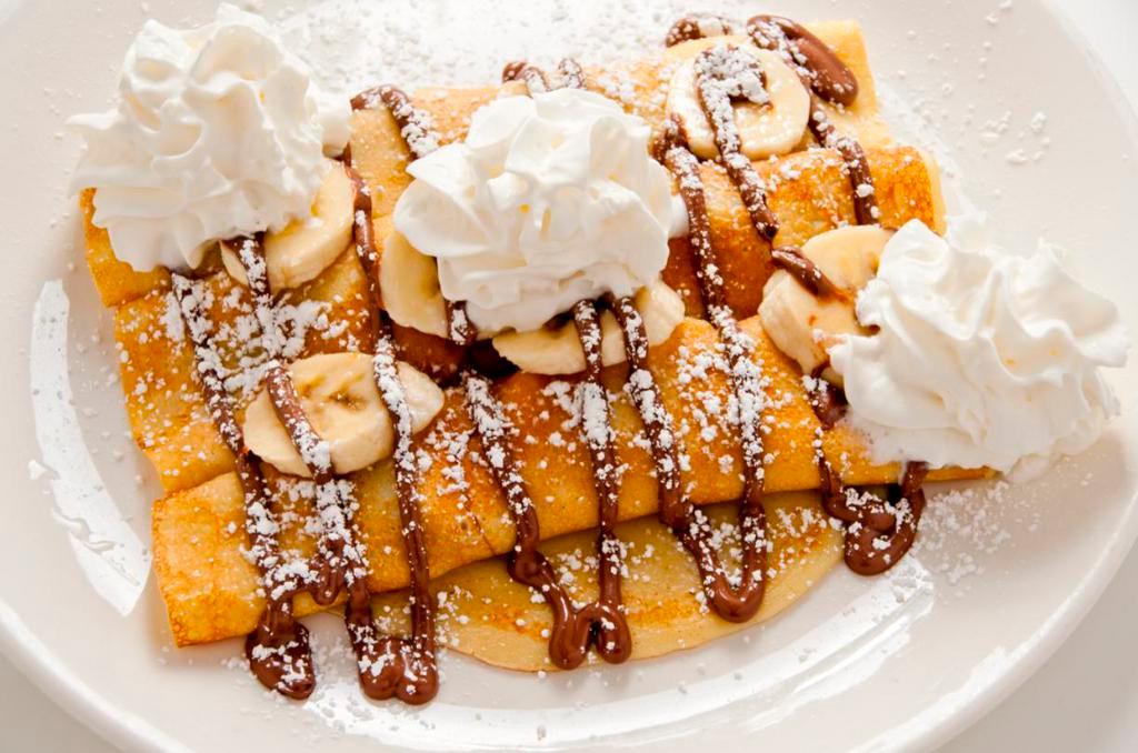 Nutella Crepes · 3 homemade crepes filled with Nutella and your choice of fresh sliced strawberries or bananas. Drizzled with more Nutella and topped with powdered sugar and whipped cream.