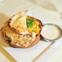 Chicken Dum Biryani · Aromatic meat between layers of fragrant, long-grain Basmati rice, cooked in a clay pot and ...