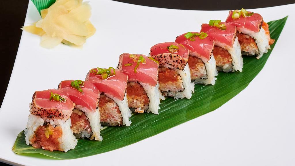 Sun's Roll · Spicy tuna, crabmeat, cucumber topped with seared ahi tuna and scallion.