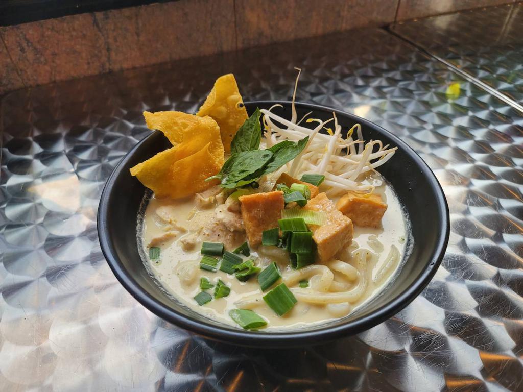 Green Curry Udon Noodle Soup · Thai green curry udon noodle soup with chicken, fried tofu and basil. topped with scallion, bean sprout and fried wonton.
