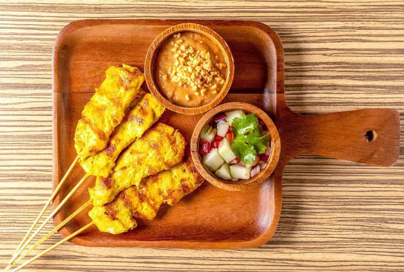 A4. Chicken Satay · 4 pieces. Chicken tenders marinated in coconut milk, thai spices, char-grilled, served with peanut sauce and cucumber salad.