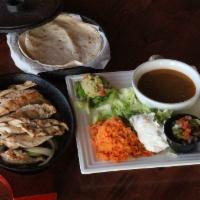 Fajitas · Your choice of steak or chicken served with flour tortillas, refried beans, spiced rice, and...