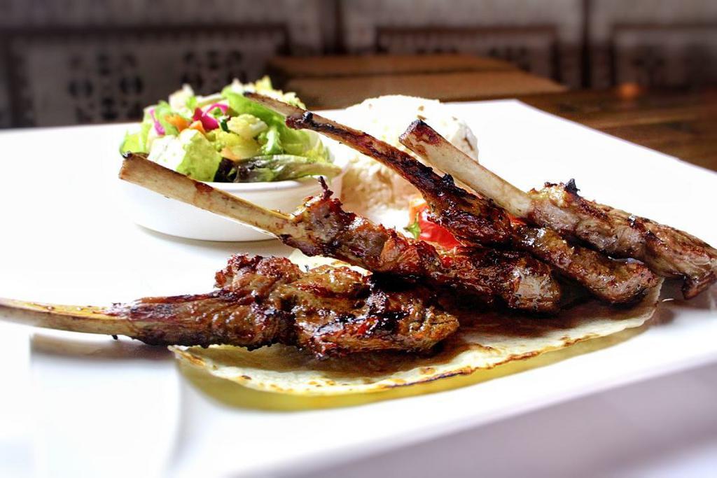 Baby Lamb Chops · Tender lamb chops marinated in our chef's special sauce and grilled to perfection. Served with house salad and choice of rice or bulgur.