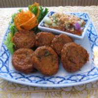 9. Fish Cake · Fish cake patties seasoned with curry paste and green bean, deep-fried, served with cucumber...