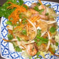 35. Yum Seafood Salad · Quick boiled combination of seafood, white mushroom, onion, mints and chili in chef’s specia...