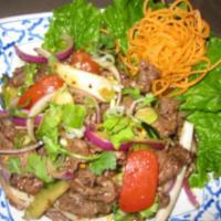 38. Yum Neur Salad · Beef salad. Grilled slices of beef, onion, cilantro, tomatoes, lettuce, mixed with lime juic...