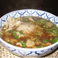 46. Thai BBQ Pork Noodle Soup · A large bowl of rice noodles soup with a rare slice of pork, well-done pork and pork ball.