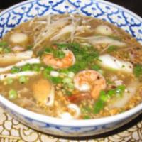 48. Tom Yum Seafood Noodle · Hot and spicy rice noodle soup with a combination of seafood, ground pork and ground peanuts.