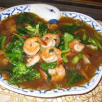 60. Rad Nar · Stir-fried soft wide rice noodle topped with gravy made of Chinese broccoli, broccoli. Choic...
