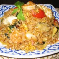 70. Curry Fried Rice · Stir-fried rice with curry, coconut milk, mint, red pepper, green pepper, onion, baby corn a...