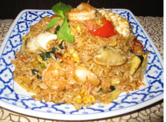 70. Curry Fried Rice · Stir-fried rice with curry, coconut milk, mint, red pepper, green pepper, onion, baby corn and bamboo. Choice of beef, pork, chicken. Substitute for shrimp or seafood for an additional charge.
