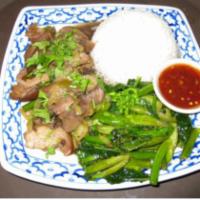 73. Kao Kha Moo · Steamed rice with stewed pork, hock and Chinese broccoli served with chili sauce.