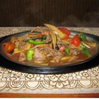 107. Siam Sizzling · Choice of chicken, beef, pork or substitute for shrimp for an additional charge with mushroo...