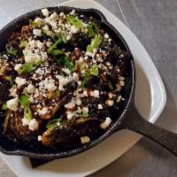 Chevre Brussels · Crispy brussels, bacon, chevre and green onion, drizzled with a balsamic reduction. Gluten-F...