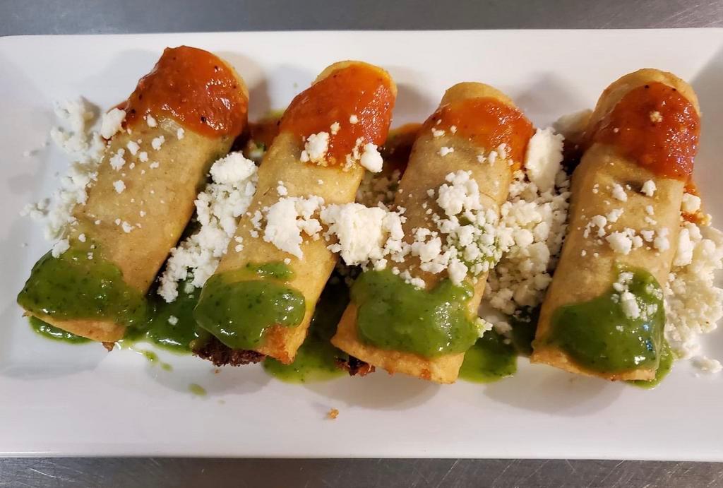 Pork Taquitos · Four corn tortillas stuffed with shredded pork and sprinkled with queso fresco, salsa de arbol and salsa verde