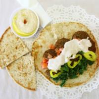 8. Falafel Sandwich Combo · Tomato, lettuce, mint, pickle and our sauce. Wrapped in pita bread. Served with side hummus,...