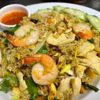 Pineapple Fried Rice · Jasmine rice with chicken and shrimp, egg, pineapple, cashew nuts, raisins, curry powder, on...