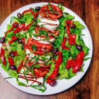 Greek Salad · Romaine lettuce, cucumbers,onions, chickpeas, tomatoes, feta, Kalamata olives & pepperoncini.