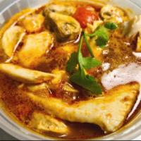 Tom Yum Soup · Tha famous Thai hot and sour soup with tomatoes, mushrooms, scallion and cilantro