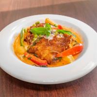 Duck Choo Chee · Crispy duck topped on choo chee curry in spicy coconut milk with peas, red and green peppers...
