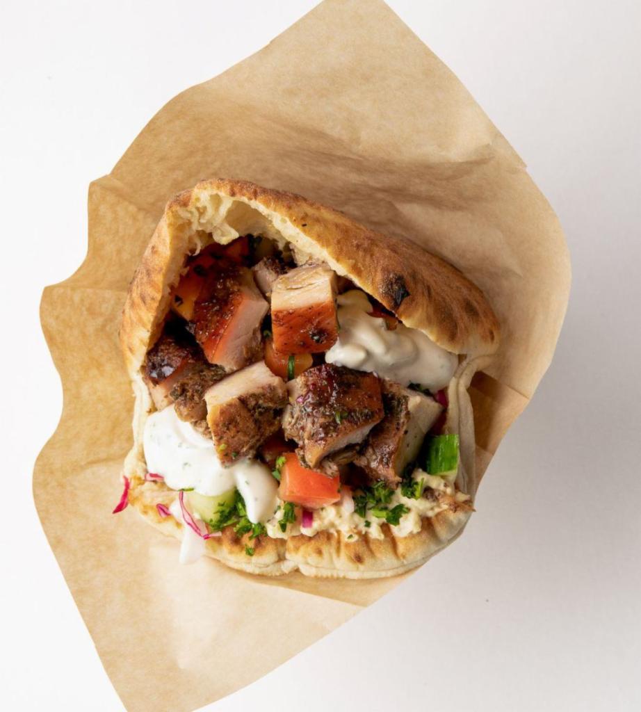 Roasted Chicken Pita · Slow roasted chicken marinated in mint, sumac and honey stuffed into a freshly baked pita pocket with hummus, israeli salad, pickled cabbage and tahini sauce.  Add toppings to customize it!  