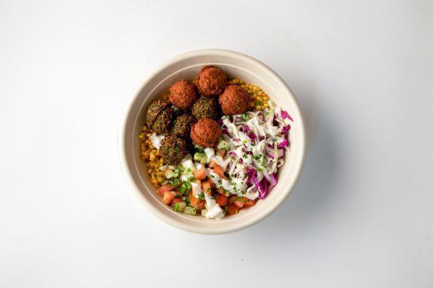 Falafel Bowl · Choose between Taïm’s traditional green falafel or harissa falafel (or a mix of both) served served over a base of your choice: creamy hummus, turmeric pearl couscous, toasted cumin rice or romaine lettuce (or choose a combo of 2 bases). Comes with Israeli salad, pickled cabbage & tahini sauce. Add toppings to customize it.