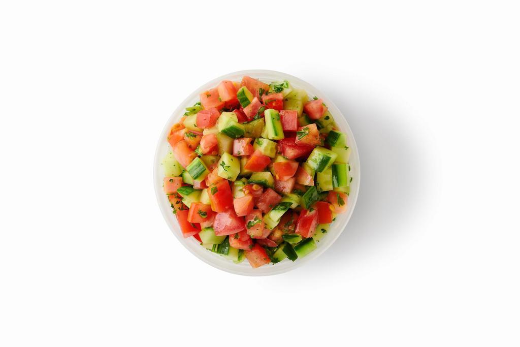 Israeli Salad · Freshly chopped tomatoes, cucumbers and parsley mixed with a vibrant lemon-mint dressing.