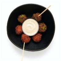 Falafel + Tahini · Choose traditional green or our spicy harissa falafel - or do a mix of both! Includes 8 fala...