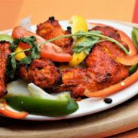 Tandoori Wings · 4 pieces. Chicken wings marinated in yogurt and mild spice and roasted in the clay oven.