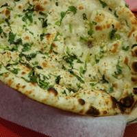 Garlic Naan · Unleavened bread stuffed with garlic baked in the clay oven.