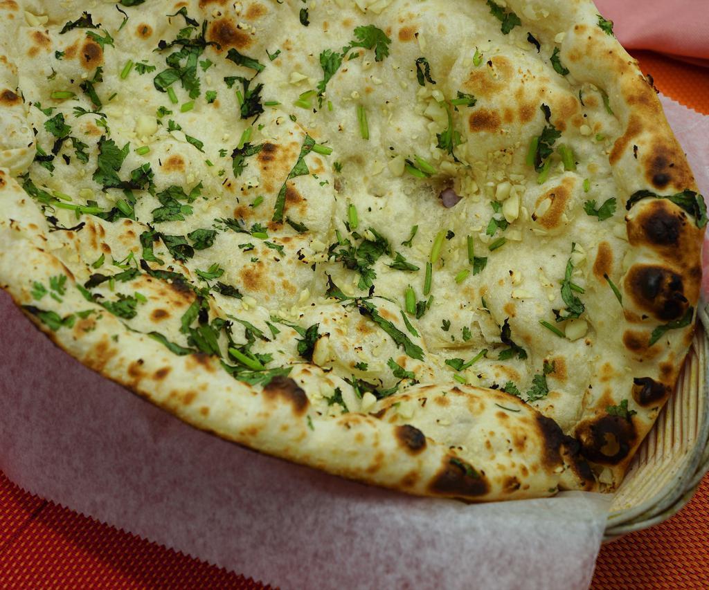 Garlic Naan · Unleavened bread stuffed with garlic baked in the clay oven.