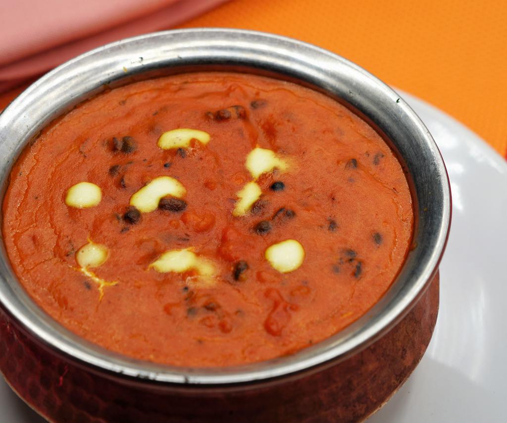 Dal Makhani · Black lentils and kidney beans cooked in spices and cream.