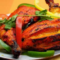 Chicken Tandoori · Chicken marinated in mild spices, grilled in a clay oven, a classic Indian tandoori favorites.