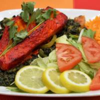 Fish Tandoori · Salmon fish marinated and grilled in a clay oven served with mushroom or spinach.