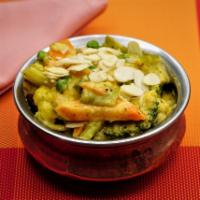 Navaratoan Korma · Seasonal vegetables cooked with dry fruits in a creamy almond cashew sauce.