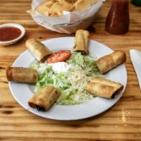 Flautas Deluxe · 6 flour tortillas: 2 chicken, 2 beef and 2 potato. Served with lettuce, sour cream and guaca...