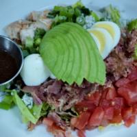 'EAT' Cobb Salad · hard-boiled egg + avocado + tomatoes + grilled chicken + green onions + diced bacon + bleu c...