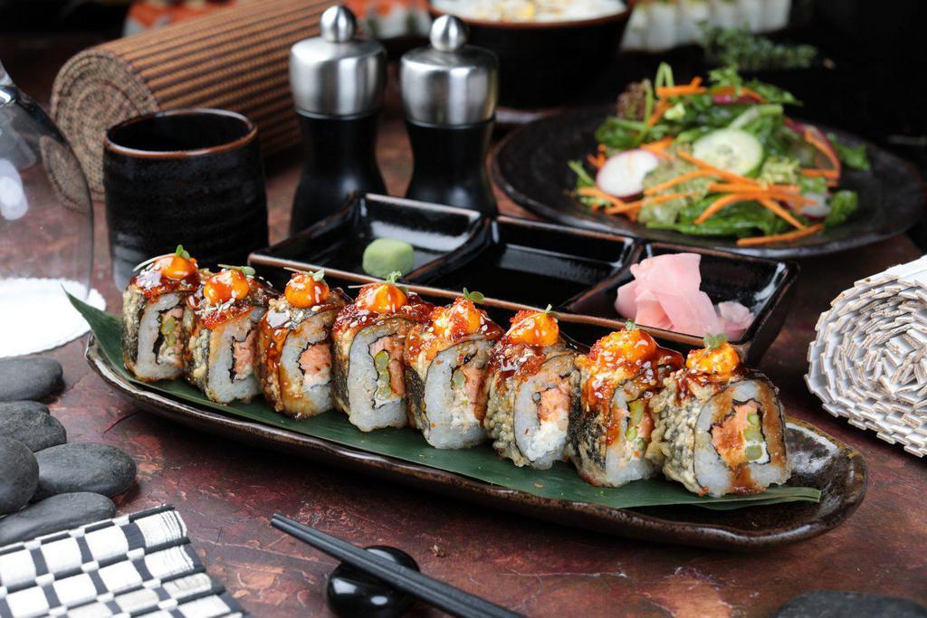 8 Pieces Dynamite Roll · Fried spicy tuna roll, topped with avocado, tobiko, and spicy mayo.