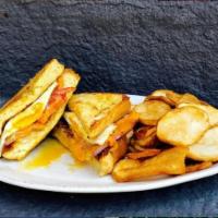 The Wynston Maple Drive Sandwich · Grilled ham, bacon, cheddar, and tomato served between 2 thick slices of french toast with m...