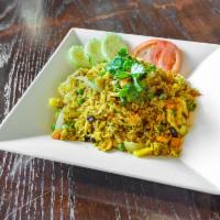 48. Yellow Curry Fried rice · Stir-fried rice with your choice of meat, egg, onions, carrot, tomatoes, green onions, pinea...