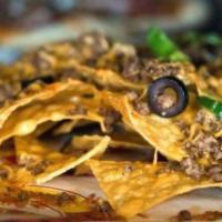 Nachos · Full order of tortilla chips, melted Colby cheese, tomatoes, lettuce, onions, black olives, ...