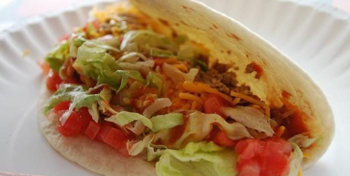 Soft Shell Taco · Taco meat or shredded chicken, lettuce, Colby cheese, tomatoes, and red grinder sauce loaded into a soft shell.