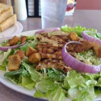 Chicken Caesar Salad · Crisp romaine tossed with our classic creamy Caesar dressing, then topped with a broiled bre...