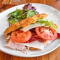 Turkey Croissant Club Sandwich · Roasted turkey, smothered with zesty mayo and cheese topped with beef bacon, lettuce and tom...